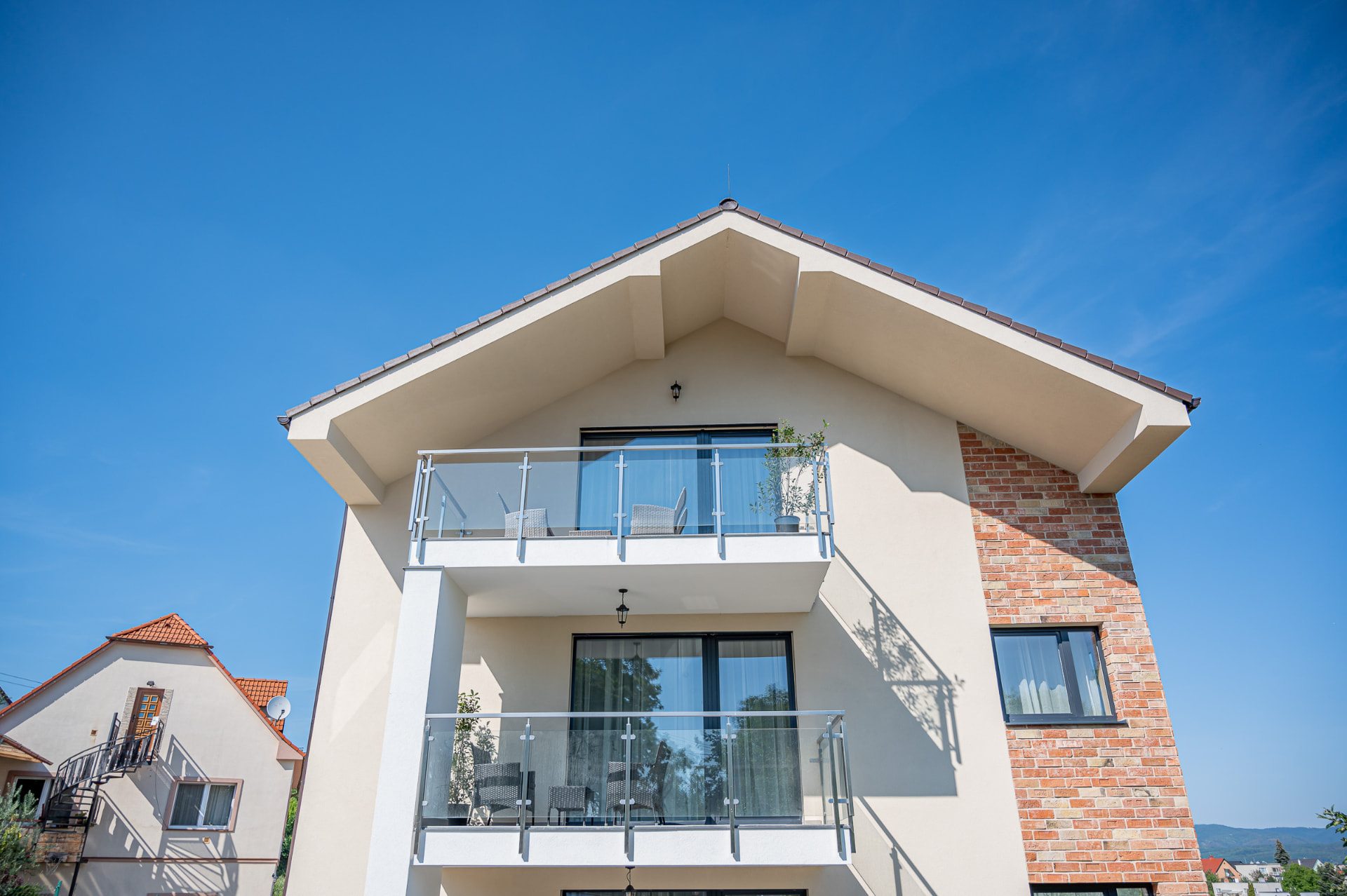 Balkóny apartmánového domu s presklenými zábradliami